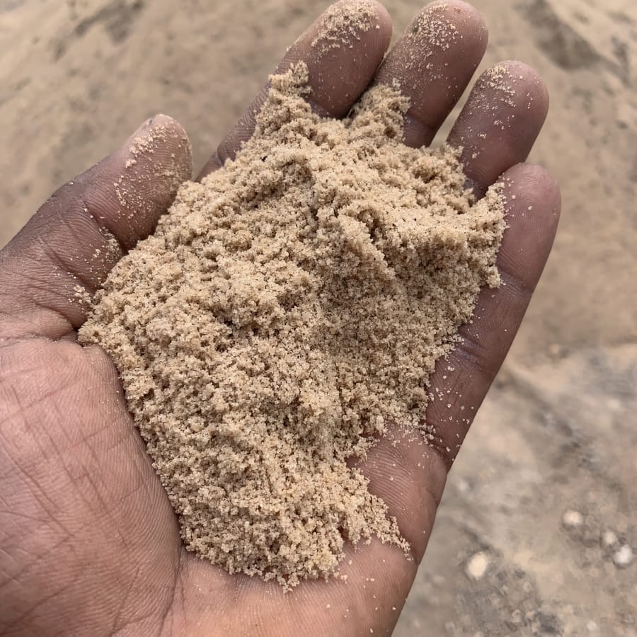 Smooth/plastering sand texture close-up, hand for scale