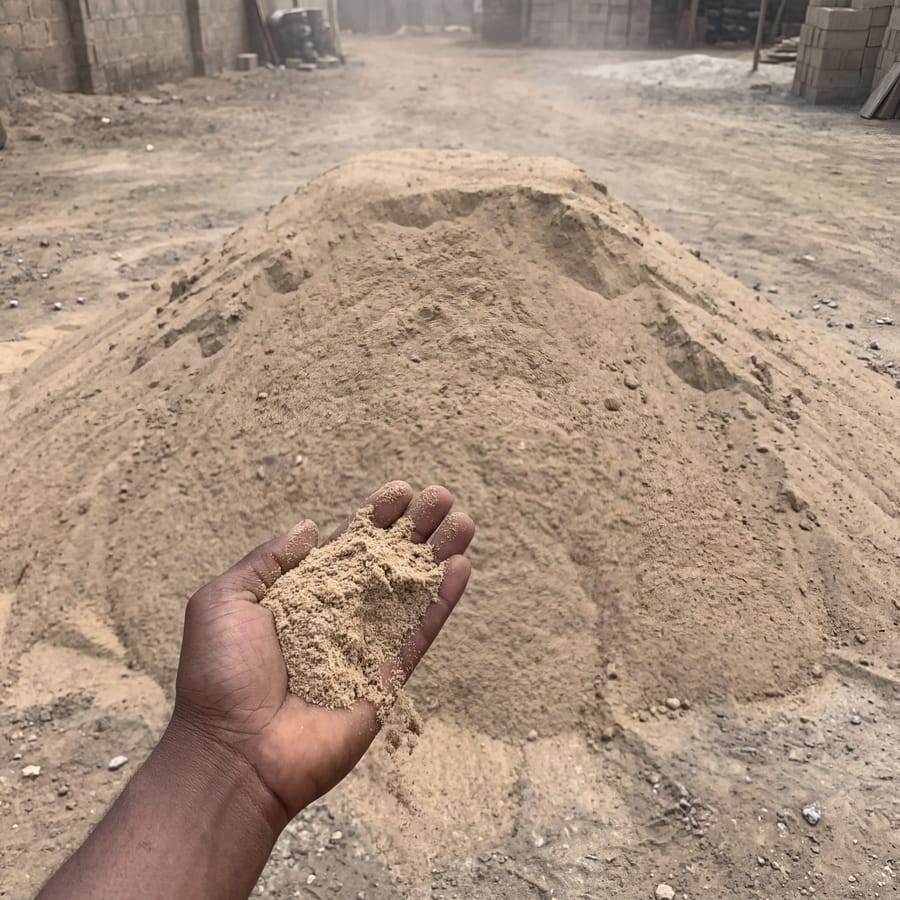 Smooth/plastering sand close-up, hand for scale