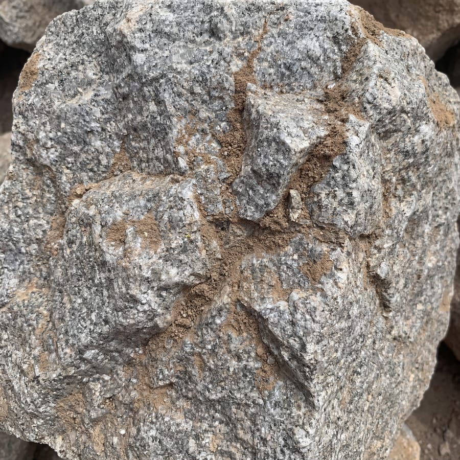 Stones/boulders texture close-up, hand for scale